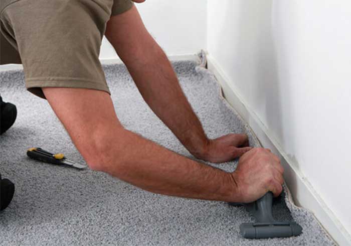 Man installing carpet | Carpet House Flooring Center